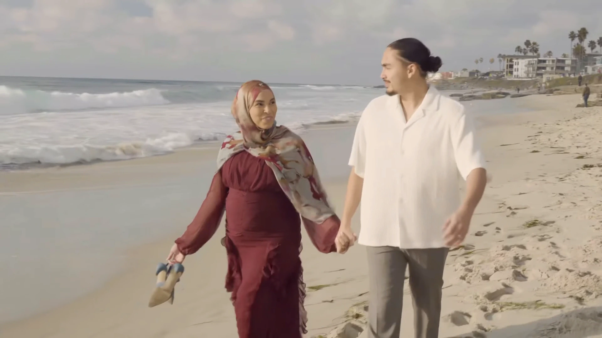 SpeakPure campaign scene with a couple walking together beside the ocean
